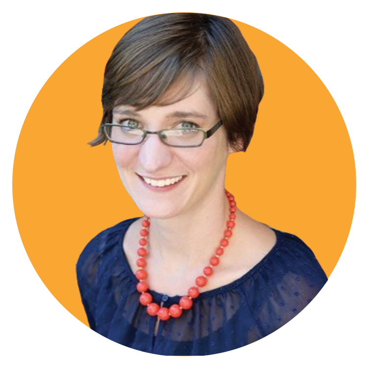 A woman with short brown hair and glasses, wearing a navy blue top and a chunky coral necklace, smiles in front of an orange circular background, reflecting the vibrant energy of a creative agency.